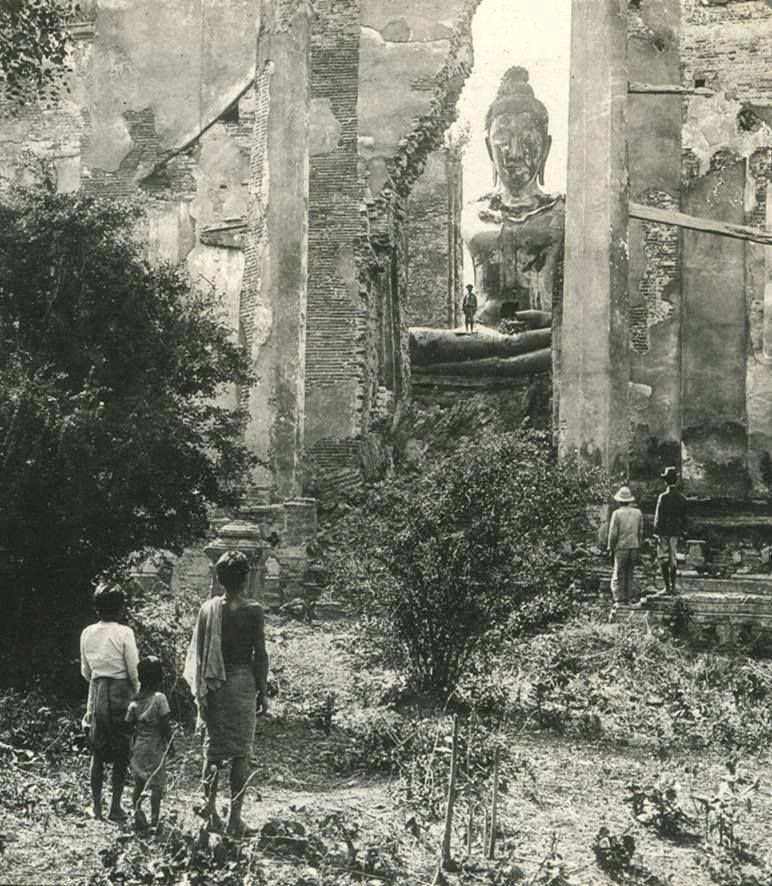 thai family admiring a giant buddha statue